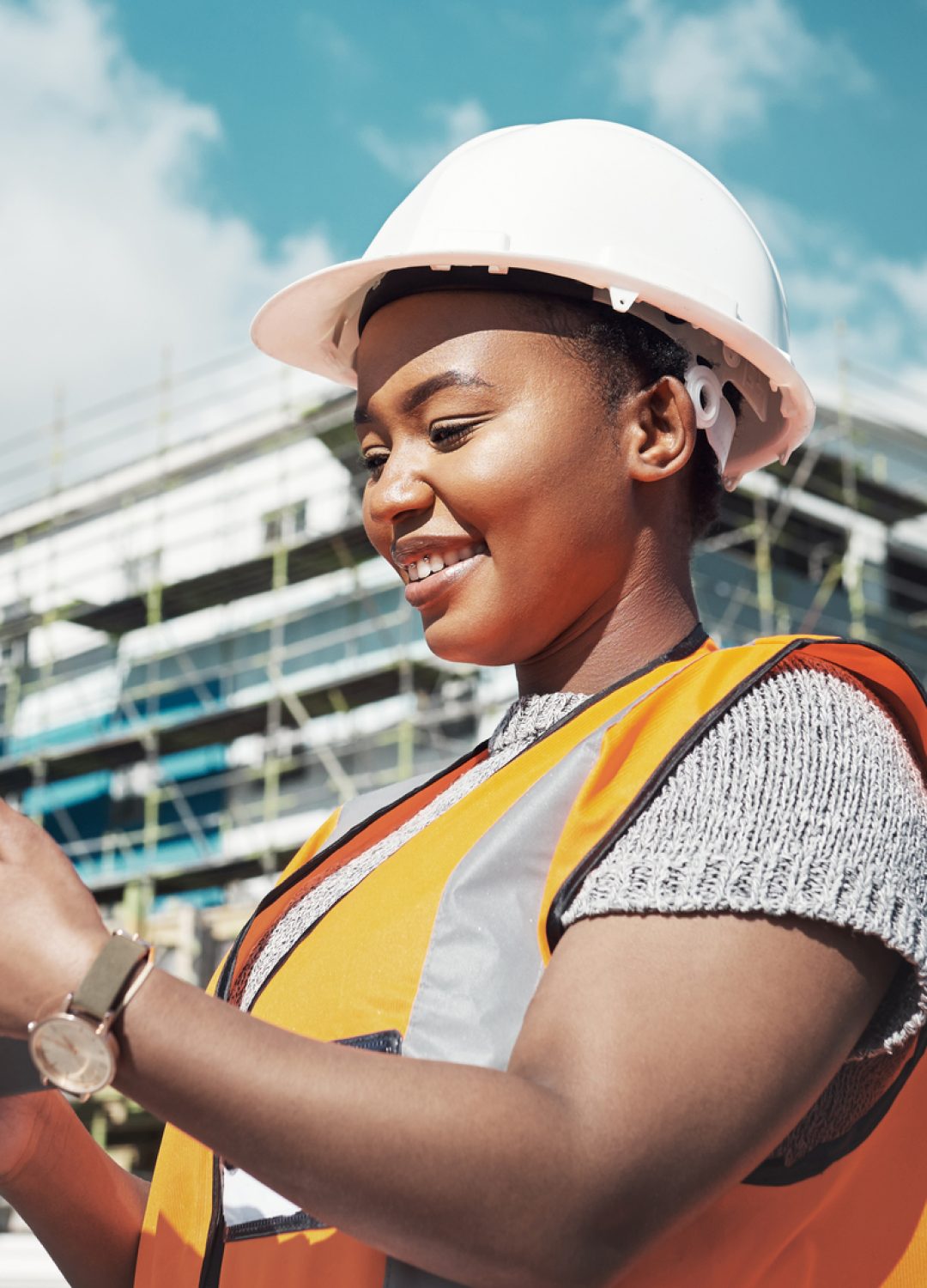 Shot of a young woman using a digital tablet while working at a construction site